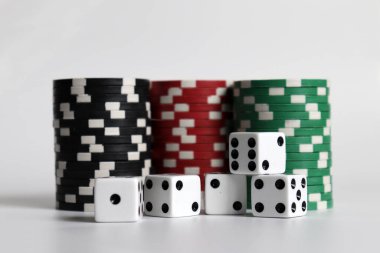 Casino chips and dice on a white background. clipart