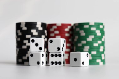 Casino chips and dice on a white background. clipart