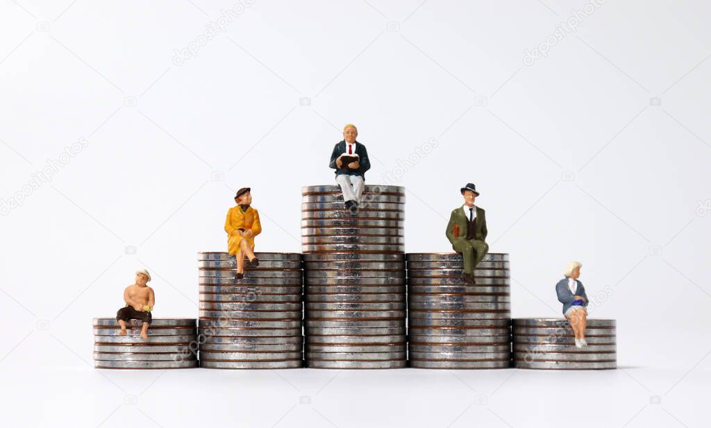 Miniature people sitting on piles of coins.
