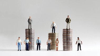Minyatür insanlarla dolu bozuk para yığını..