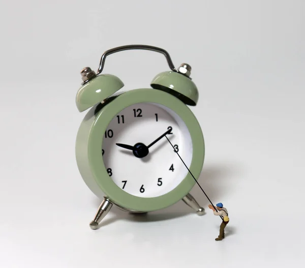 Alarm Clock Miniature Man Holding Fishing Rod — Stock Photo, Image