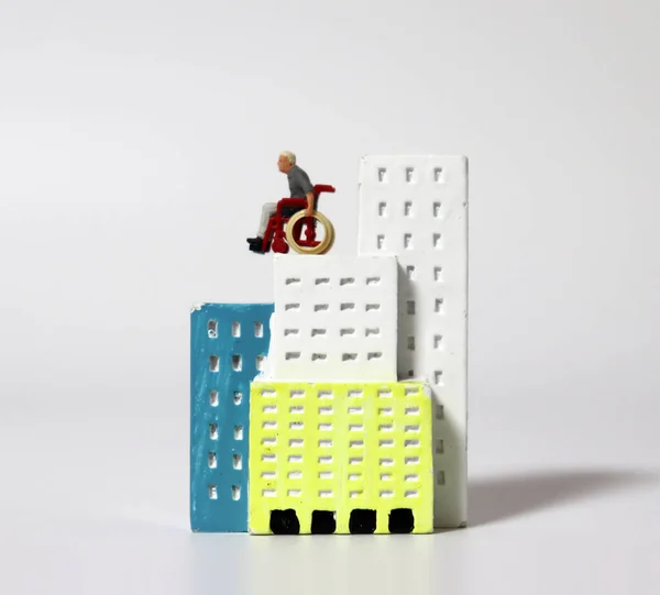 Ein Miniaturmann Rollstuhl Einem Miniaturgebäude — Stockfoto