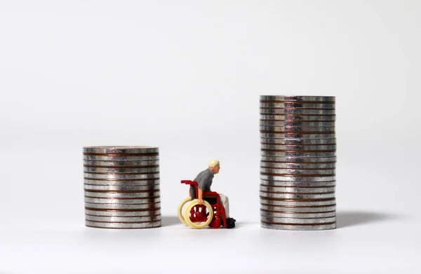 Miniature Man Wheelchair Two Pile Coins — Stock Photo, Image