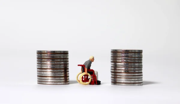 Miniature Man Wheelchair Two Pile Coins — Stock Photo, Image