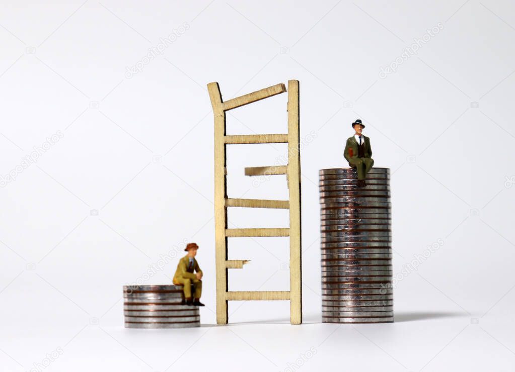 Miniature wood broken ladder and miniature men sitting on the pile of coins. The concept of economic inequality.