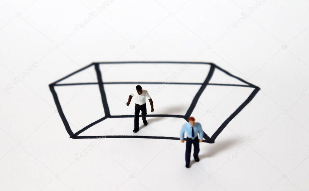 Miniature people with a rectangle of black solid lines. A concept of racism.