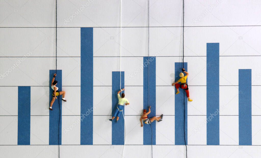 A competitive concept for promotion in the workplace. The miniature climbers use a rope to climb the three dimensions bar graph.