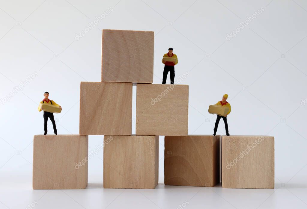 Miniature couriers standing on wooden blocks.