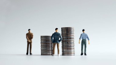 İki para yığını ve üç minyatür adamın sırtı..