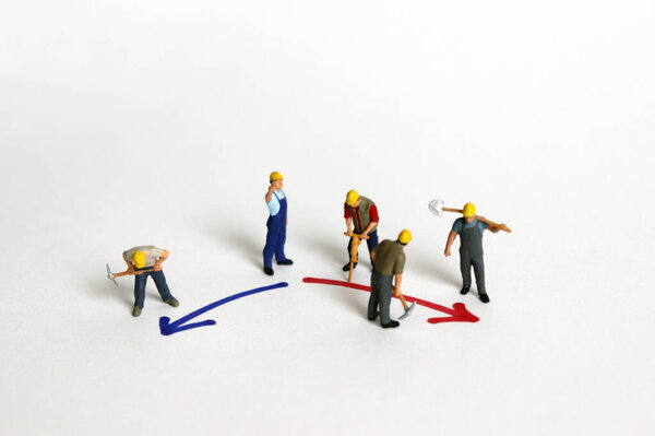 Two colors direction and miniature workers.