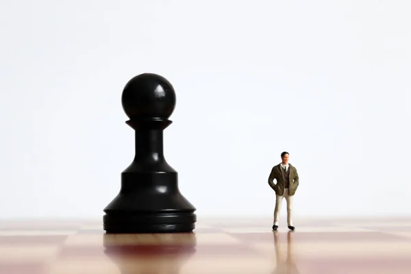 Miniature Man Standing Side Side Black Pawn Chessboard — Stock Photo, Image