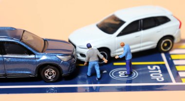 Drivers Arguing After Traffic Accident. Miniature people and miniature cars.  clipart