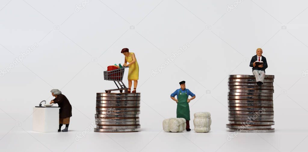 The concept of income disparity. Miniature people working on different tasks.