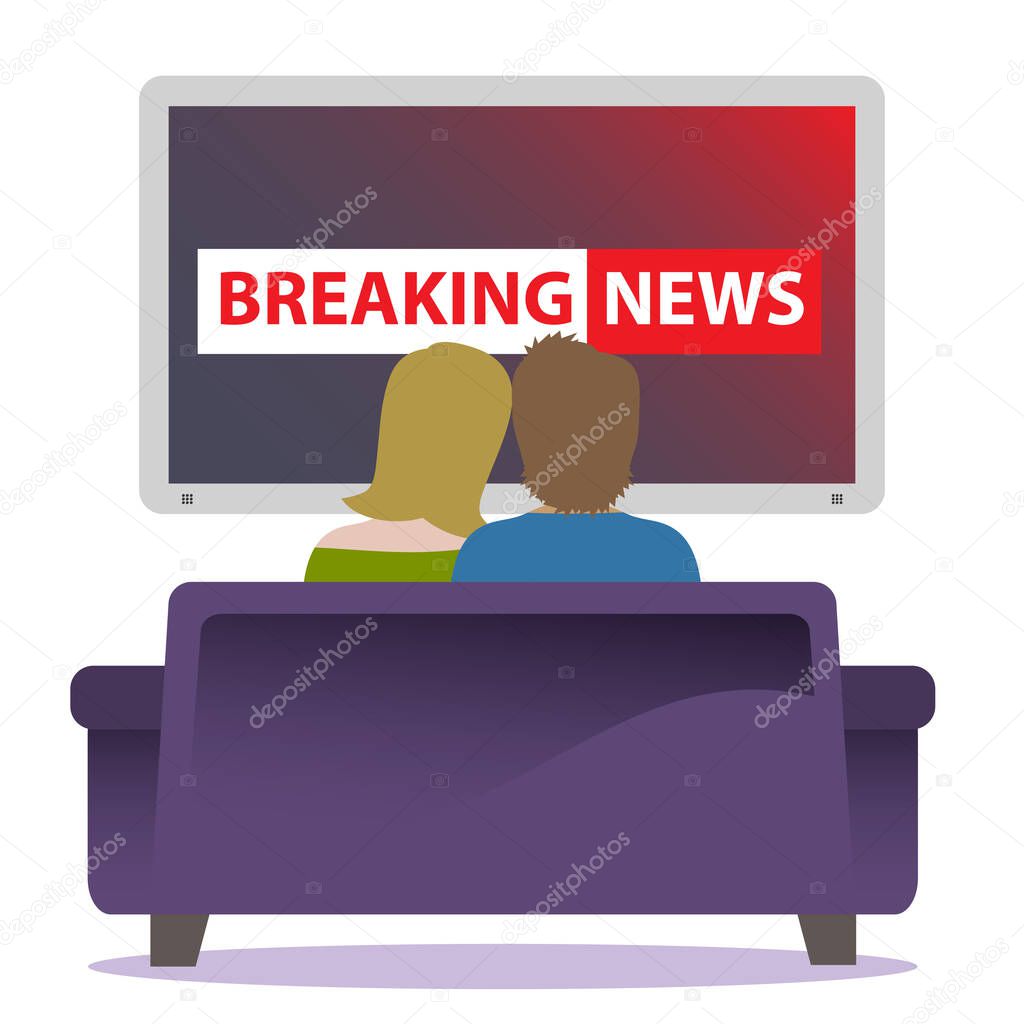 A couple sitting together on a cozy couch watching breaking news on TV.