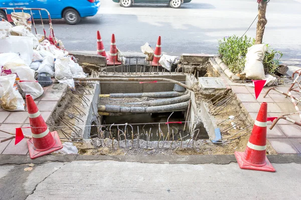 Sewer repair work on the sidewalk.