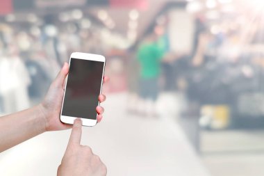 Alışveriş merkezi bulanık arkaplanlı cep telefonu.