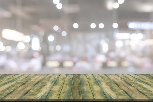 Wooden table with blur restaurant background