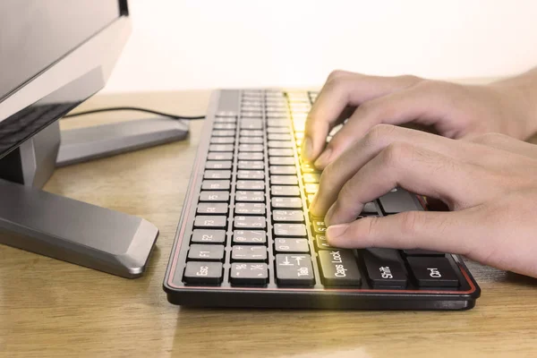 Close up of typing male hands on black keyboard,Businessman working concept,light effect