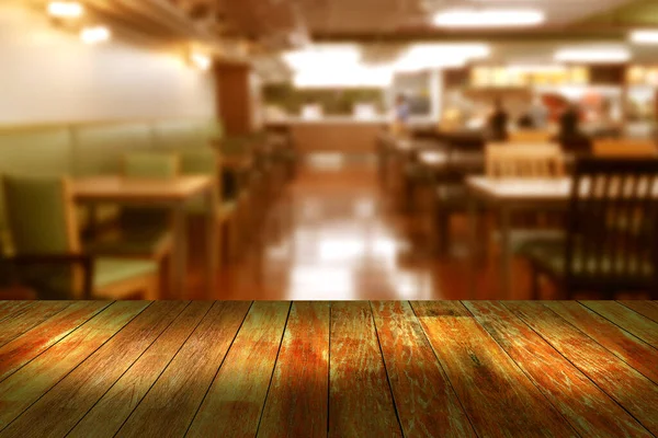 Top desk with blur restaurant background,wooden table