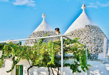 Trulli, geleneksel Apulian kuru taş kulübesi Itria Vadisi, Puglia, İtalya 'da koni çatısı olan, kırsalda üzüm bağı olan eski evler. 