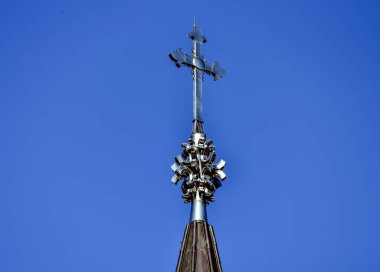 Orthodox metal cross on the roof of the church on the blue sky, from Poiana Sibiului Romania