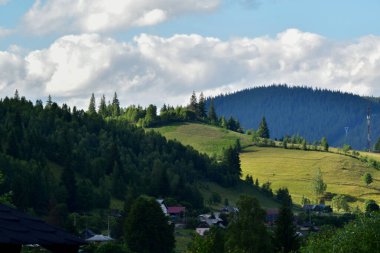 carpathian mountain landscape in the summer season. the village on the slopes of a mountain range