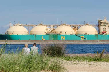 SWINOUJSCIE, WEST POMERANIAN / POLAND - 2020: The LNG carrier SOKOTO unloads gas at the terminal in the seaport clipart