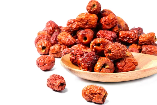 dried unabi fruit or jujube in wood spoon of on white background. Chinese dried red date fruit. copy space for text.
