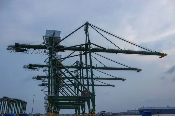 Industrial crane formation in export import and commercial port in Jakarta, gantry cranes ready for loading and discharging cargo from vessels