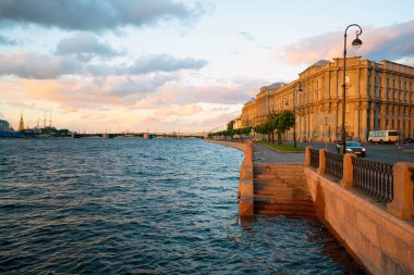 Makarova embankment, in the evening at sunset in the direction of the exchange bridge. Saint-Petersburg clipart