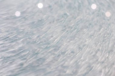 Sıvı bir sistemde dairesel dalga hareketi. Dairesel bir hareketin içine itilmiş bir sıvı için mavi gri arka plan. Soyut ve genel arkaplan olarak dalgalı dalgalar ve eş merkezli çemberler. hızlı dalgalanmalar