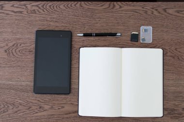 Tablet, defter, kalem ve SD kartları. Bir gazeteci ve blog yazarı için çalışma alanı kurmak. Gazetecilik, veri analisti, blogcu ve nüfuz sahibi için görüntü. Çevrimiçi iletişim ve sosyal medya, kelimeler ve resimler