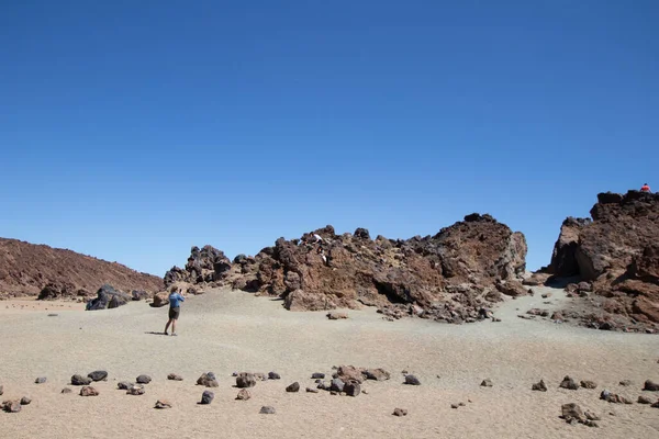 mountain desert with volcanic rocks, panorama of a rocky desert with red earth and sand