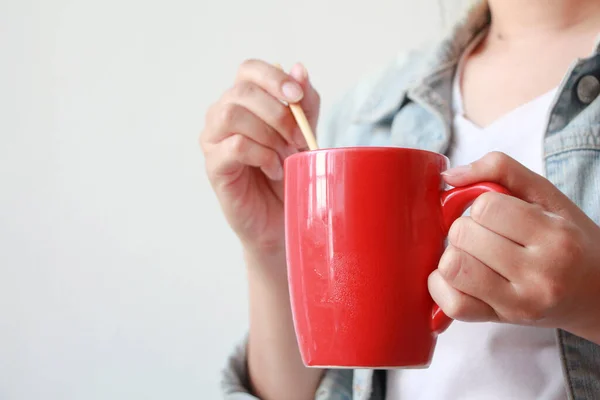 woman hands holding red mug of hot tea in morning.Drink Tea relax cozy day. happy concept.