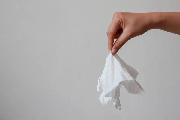 Beautiful hand holding tissue paper on white background. drity tissue.