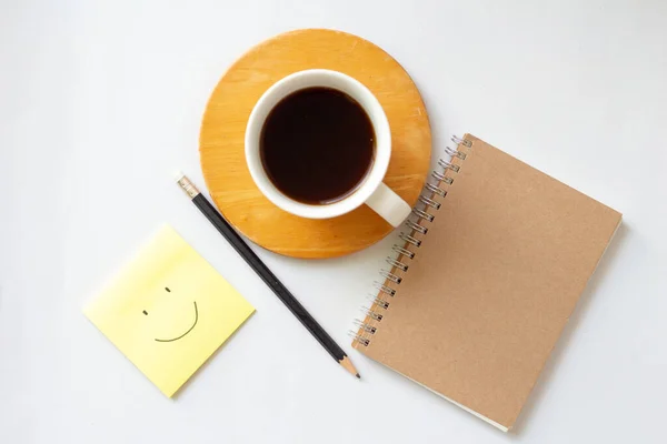 cup of coffee and notebook on table