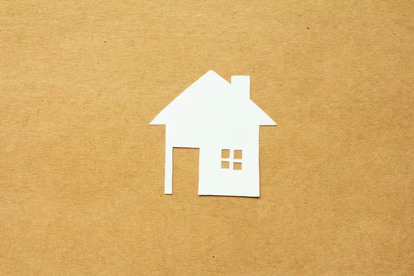 Paper cut of love family house on brown background, happy family concept.