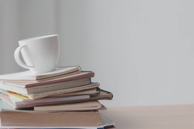 Ofis masasında yığın halinde bir fincan kahve. Boşluğu kopyala.