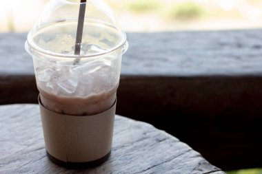 Kafedeki ahşap masada bir bardak çikolata.