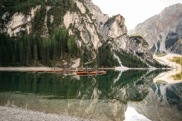 Clean lake with boats among the mountains, Alps in spring