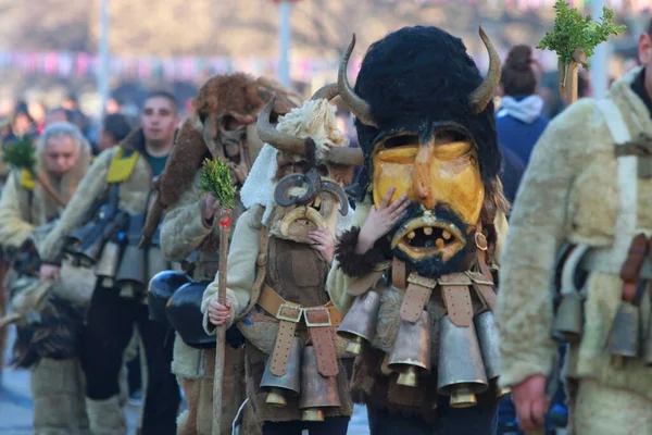 stock image Pernik, Bulgaria - January 28, 2019: People with mask called Kukeri dance and perform to scare the evil spirits at the International Festival of Masquerade Games Surva in town Pernik, Bulgaria.