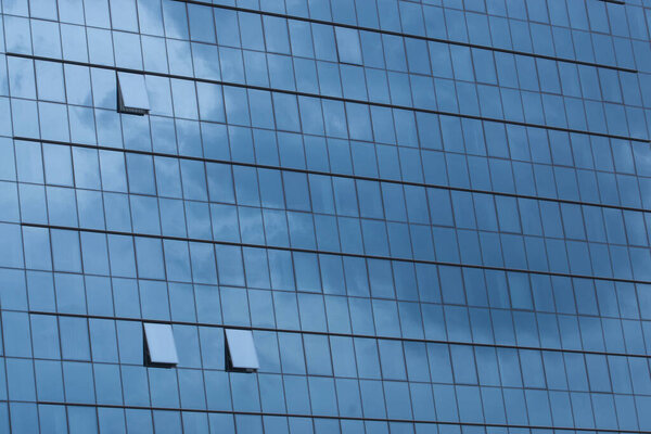 Sky reflecting in windows of office building