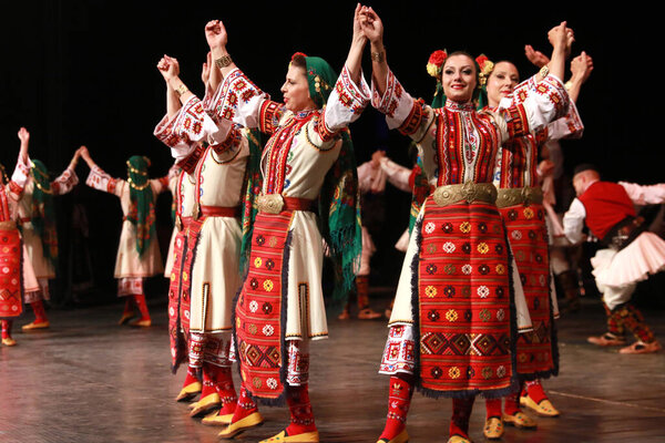 Sofia, Bulgaria - May 2, 2018: People in traditional folklore costumes perform folk dance horo on National folklore fair in the Sofia, Bulgaria 