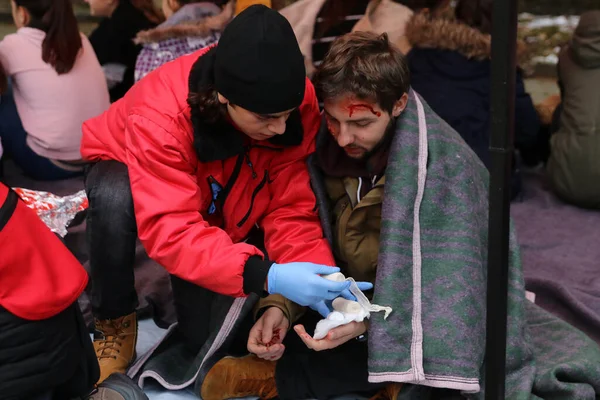 Sofia, Bulgaria - December 5, 2018: Volunteers from the organization of the Bulgarian Red Cross participate in training with a fire service. They help provide first aid to people after an earthquake and fire