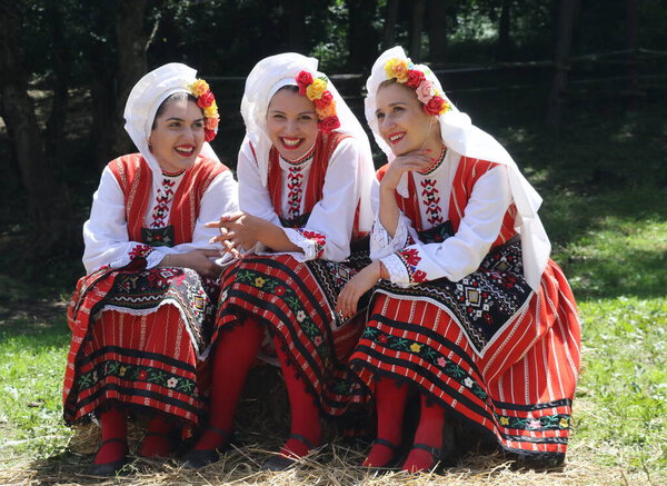 Vratsa, Bulgaria - June 24, 2018: People in traditional authentic folk costumes, recreating the traditional Bulgarian northern wedding on National folklore fair "Ledenika", near the Ledenika cave in the Vratsa Balkan - Ledenika area