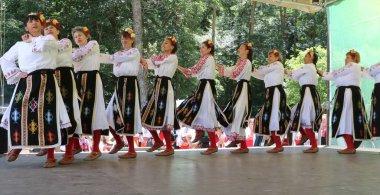 Vratsa, Bulgaria - June 24, 2018: People in traditional authentic folk costumes, recreating the traditional Bulgarian northern wedding on National folklore fair 
