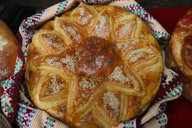 Geleneksel Bulgar tekstil ürünlerinde taze pişmiş ev yapımı ekmek. Lezzetli ev yapımı fırın ürünlerinin görüntüsü.