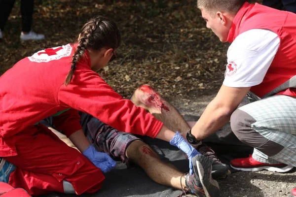 stock image Sofia, Bulgaria - December 5, 2019: Volunteers from Bulgarian Red Cross Youth (BRCY) participate in training with a fire service. They help provide first aid to people after an earthquake and fire of a natural disaster situation.