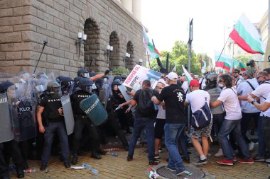 Sofia, Bulgaria - September 2, 2020: Clashes between the gendarmerie and protesters during an anti-government protest in front of the parliament building. Thousands of protesters are demanding the resignation of Prime Minister Boyko Borissov clipart