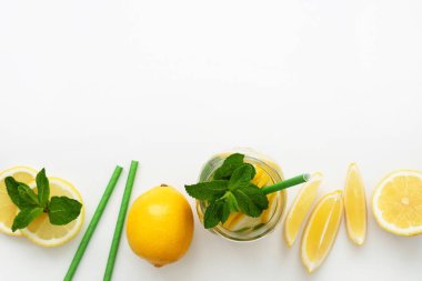 Tazeleyici yaz içeceği. Limonata, limon dilimleri, nane yaprakları ve kağıt kamışlar. Üst Manzara. Boşluğu kopyala.